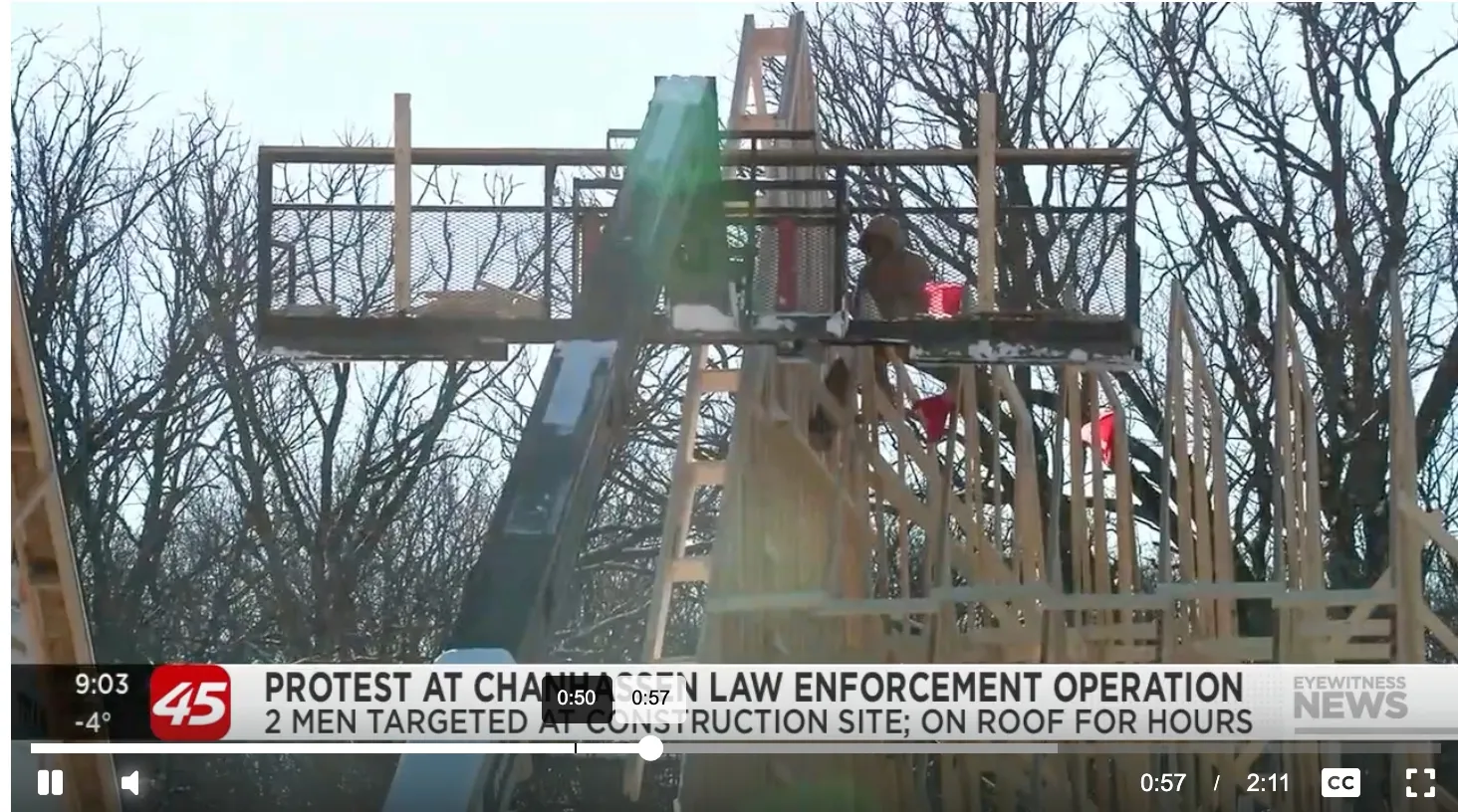 Photograph from the Minneapolis construction-site scene showing federal agents in tactical gear behind a cordon.